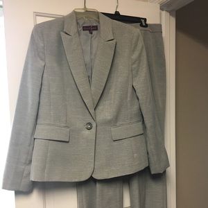 Gray women’s power suit with single button closure